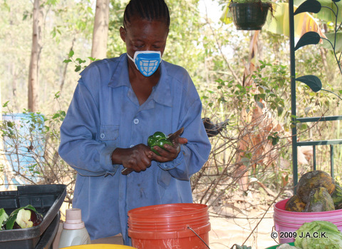 Maman Maguy preparing food.